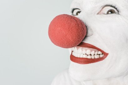 smiling-clown-with-red-nose-on-white-background
